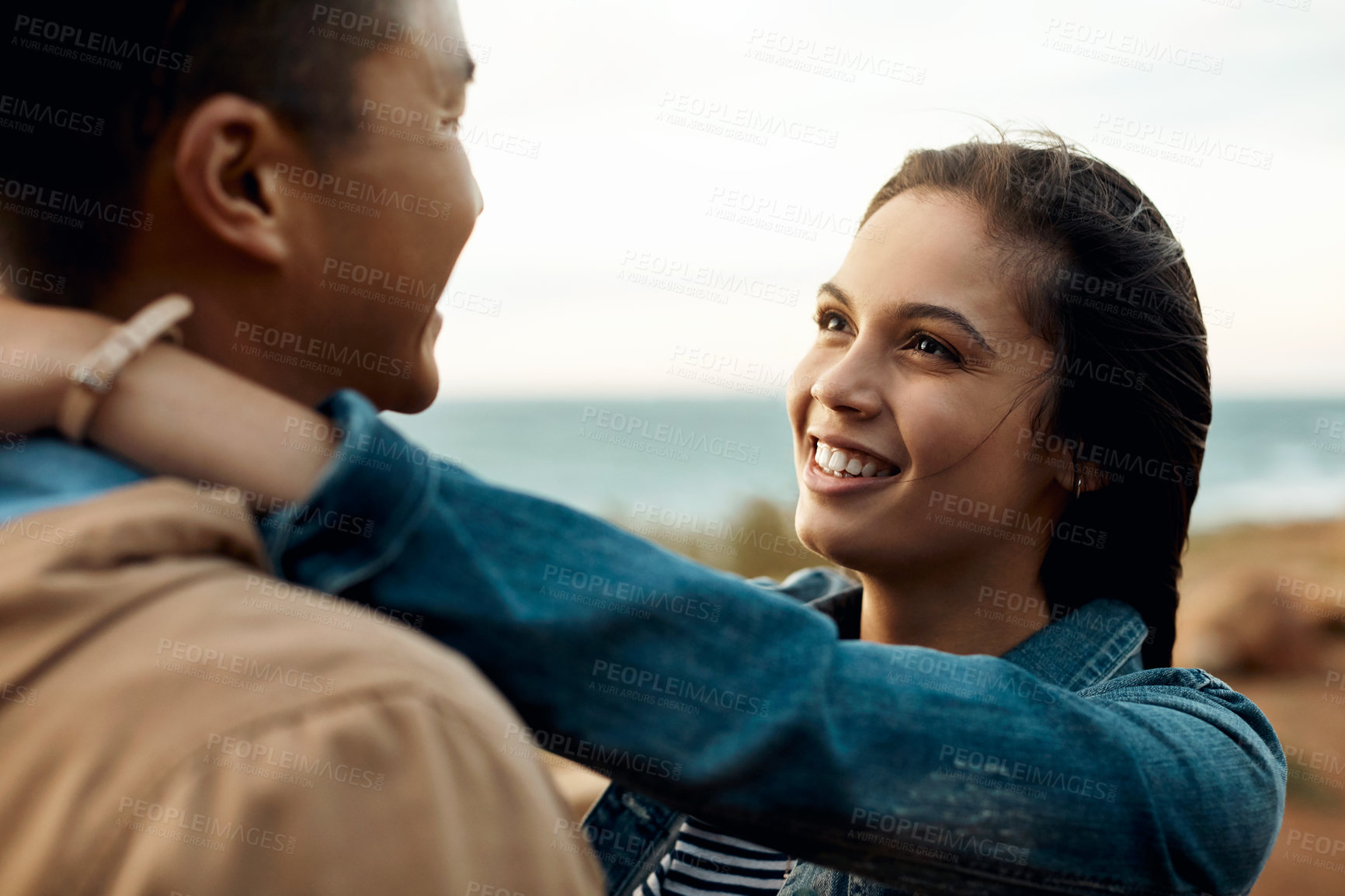 Buy stock photo hot of a happy young couple sharing a romantic moment on a vacation along the coast