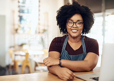 Buy stock photo Cropped shot of a young coffee shop owner sitting in her shop