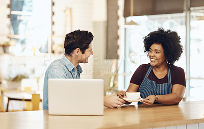 Buy stock photo Shot of a young woman serving a customer in a cafe