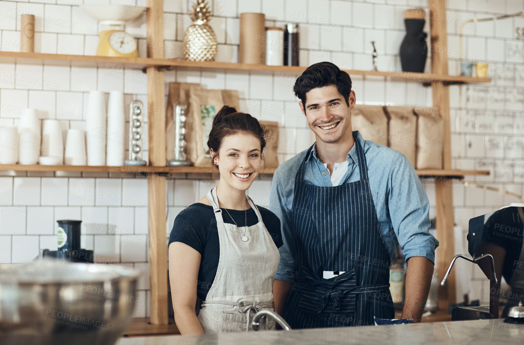 Buy stock photo Cropped shot of two business partners standing together in their cafe