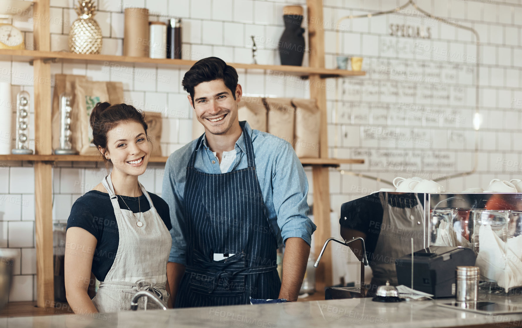 Buy stock photo Cropped shot of two business partners standing together in their cafe