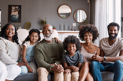 Buy stock photo Portrait of a beautiful multi-generational family posing together on a sofa at home