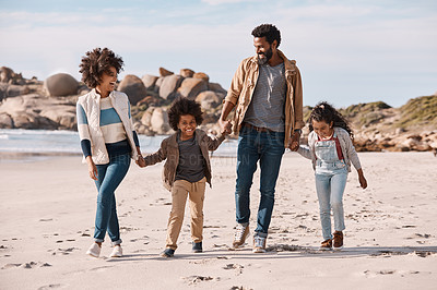 Buy stock photo Shot of an adorable little boy and girl going for a walk along the beach with their parents