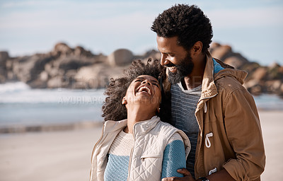 Buy stock photo Shot of a happy young couple spending a romantic day at the beach