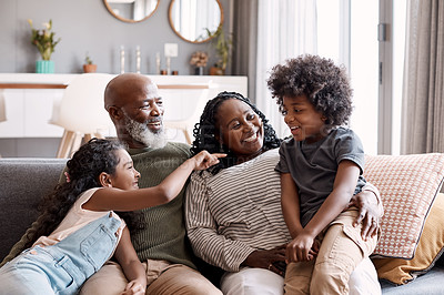 Buy stock photo Shot of two adorable young siblings bonding and spending time with their grandparents at home
