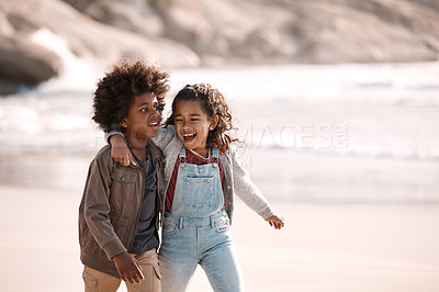 Buy stock photo Shot of an adorable little boy and girl having fun together at the beach