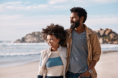 Buy stock photo Shot of a happy young couple going for a romantic walk along the beach