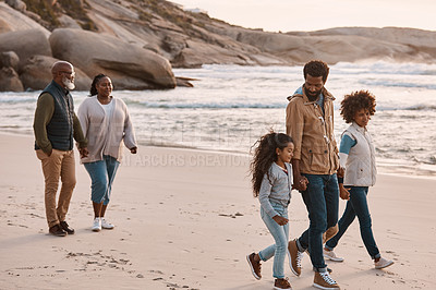 Buy stock photo Shot of an adorable little girl having a fun day at the beach with her parents and grandparents