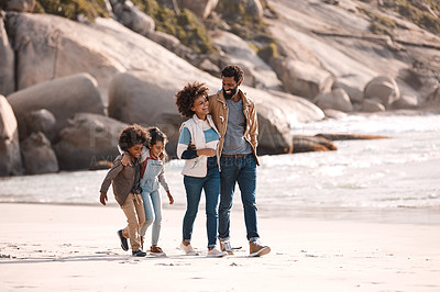 Buy stock photo Shot of an adorable little boy and girl going for a walk along the beach with their parents