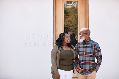 Buy stock photo Shot of a mature couple standing outside their home