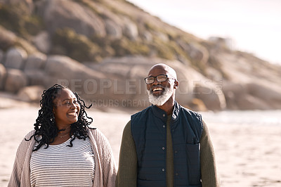 Buy stock photo Shot of a happy mature couple going for a romantic walk along the beach