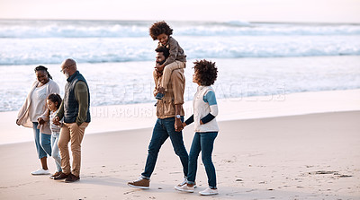 Buy stock photo Shot of an adorable little boy and girl having a fun day at the beach with their parents and grandparents