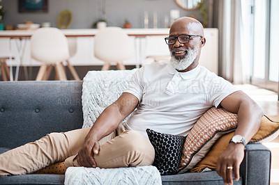 Buy stock photo Portrait of a mature man relaxing on a sofa at home