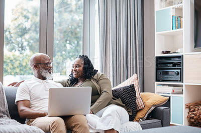 Buy stock photo Shot of a mature couple using a laptop together at home