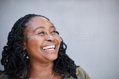 Buy stock photo Shot of a mature woman looking thoughtful while standing against a grey background