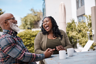 Buy stock photo Shot of a mature couple drinking coffee while having a chat outdoors