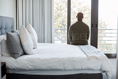 Buy stock photo Rearview shot of a mature man looking through a window in a bedroom at home