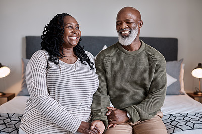 Buy stock photo Shot of a mature couple sitting together in their bedroom at home
