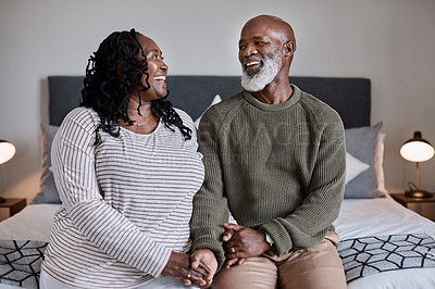 Buy stock photo Shot of a mature couple sitting together in their bedroom at home