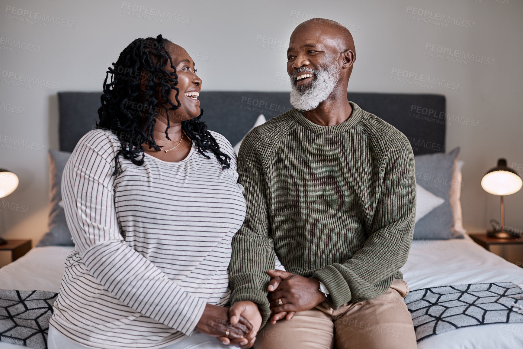 Buy stock photo Shot of a mature couple sitting together in their bedroom at home