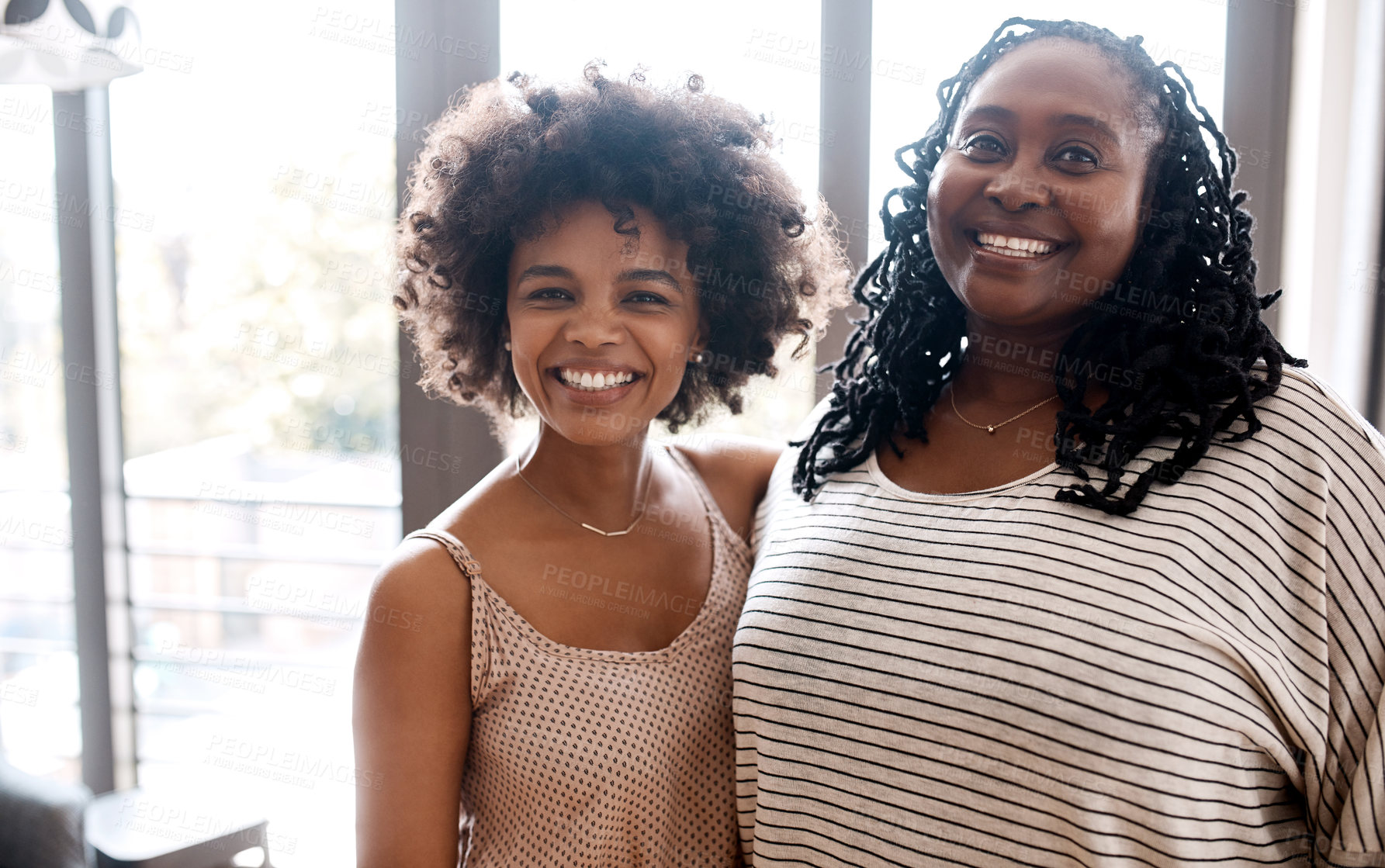 Buy stock photo Portrait of a happy young woman bonding and spending time with her mother at home