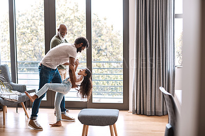 Buy stock photo Full length shot of an adorable little girl dancing with her father and grandfather at home