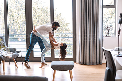 Buy stock photo Full length shot of an adorable little girl dancing with her father at home
