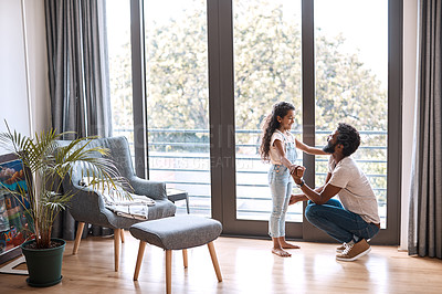 Buy stock photo Full length shot of an adorable little girl dancing and spending time with her father at home