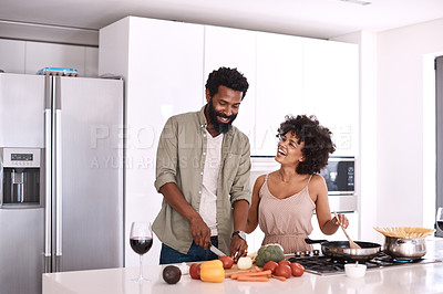Buy stock photo Cropped shot of a couple cooking together in their kitchen