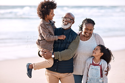 Buy stock photo Shot of an adorable little boy and girl spending time with their grandparents at the beach