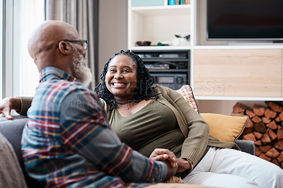 Buy stock photo Shot of a mature couple relaxing together on a sofa at home