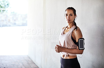 Buy stock photo Cropped portrait of an attractive young female athlete working out in the city