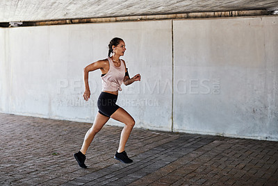 Buy stock photo Full length shot of an attractive young female athlete working out in the city