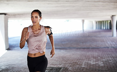 Buy stock photo Cropped shot of an attractive young female athlete working out in the city
