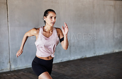 Buy stock photo Cropped shot of an attractive young female athlete working out in the city