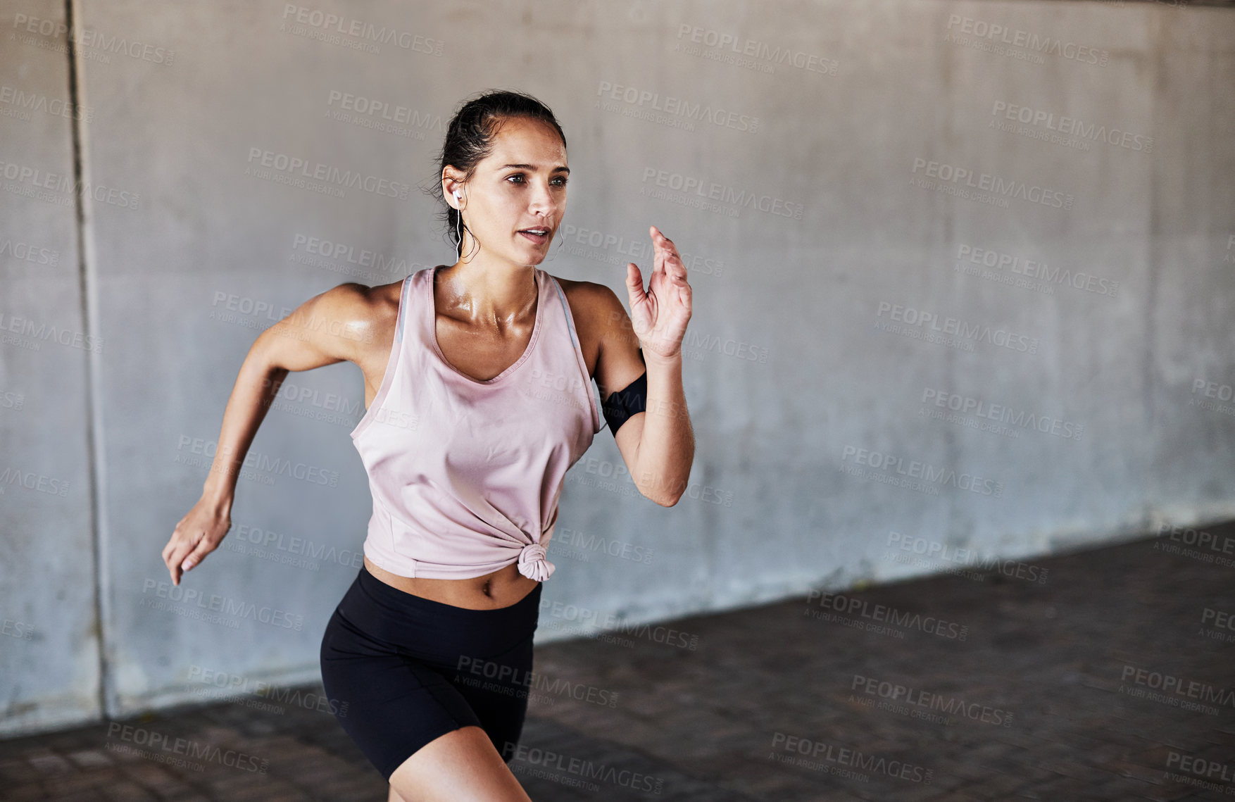 Buy stock photo Cropped shot of an attractive young female athlete working out in the city