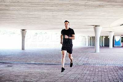 Buy stock photo Full length shot of a handsome young male athlete working out in the city