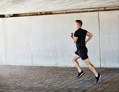 Buy stock photo Full length shot of a handsome young male athlete working out in the city