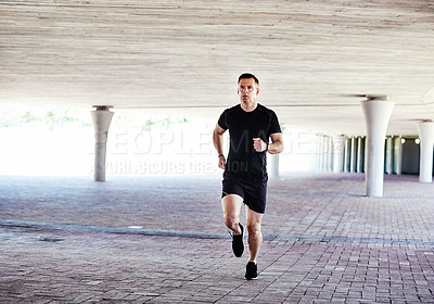 Buy stock photo Full length shot of a handsome young male athlete working out in the city
