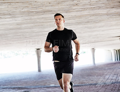 Buy stock photo Cropped shot of a handsome young male athlete working out in the city