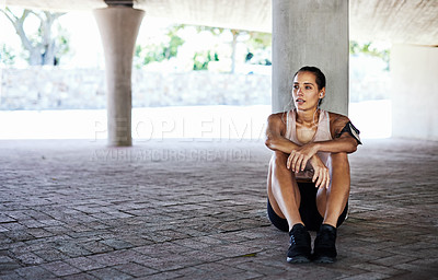 Buy stock photo Full length shot of an attractive young female athlete resting during her workout in the city