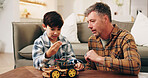 Father, son and building toy car in home for bonding together, skill or learning for child development. Man, boy kid and help in lounge with plastic vehicle assembly, parent advice or problem solving