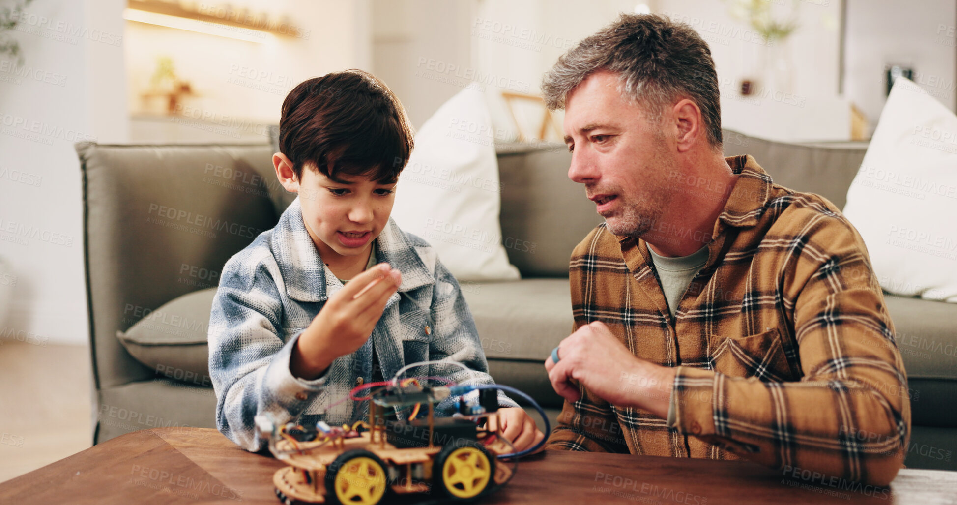 Buy stock photo Father, son and building toy car in home for bonding together, skill or learning for child development. Man, boy kid and help in lounge with plastic vehicle assembly, parent advice or problem solving