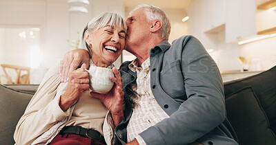 Buy stock photo Coffee, kiss and old couple in home with laugh, funny joke or bonding together for retirement wellness. Happy, married senior people and tea in living room with affection, humor and love connection.