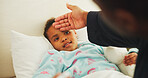 Fever, hand and parent with child in bed of family home for sick, illness and influenza symptom. Medical, support and cold season with kid and person in bedroom of apartment for help and healthcare