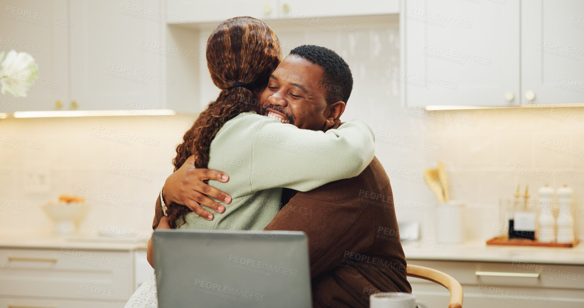Buy stock photo Happy, hug and black couple with laptop in kitchen for love, affection or support together in home. Man, woman or smile with embrace, comfort or trust for achievement, good news or success in house
