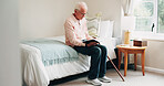 Senior, man and reading with bible in home for religion, belief or holy study in retirement. Elderly, male person or pensioner with book of god for faith, spiritual wellness or connection in bedroom