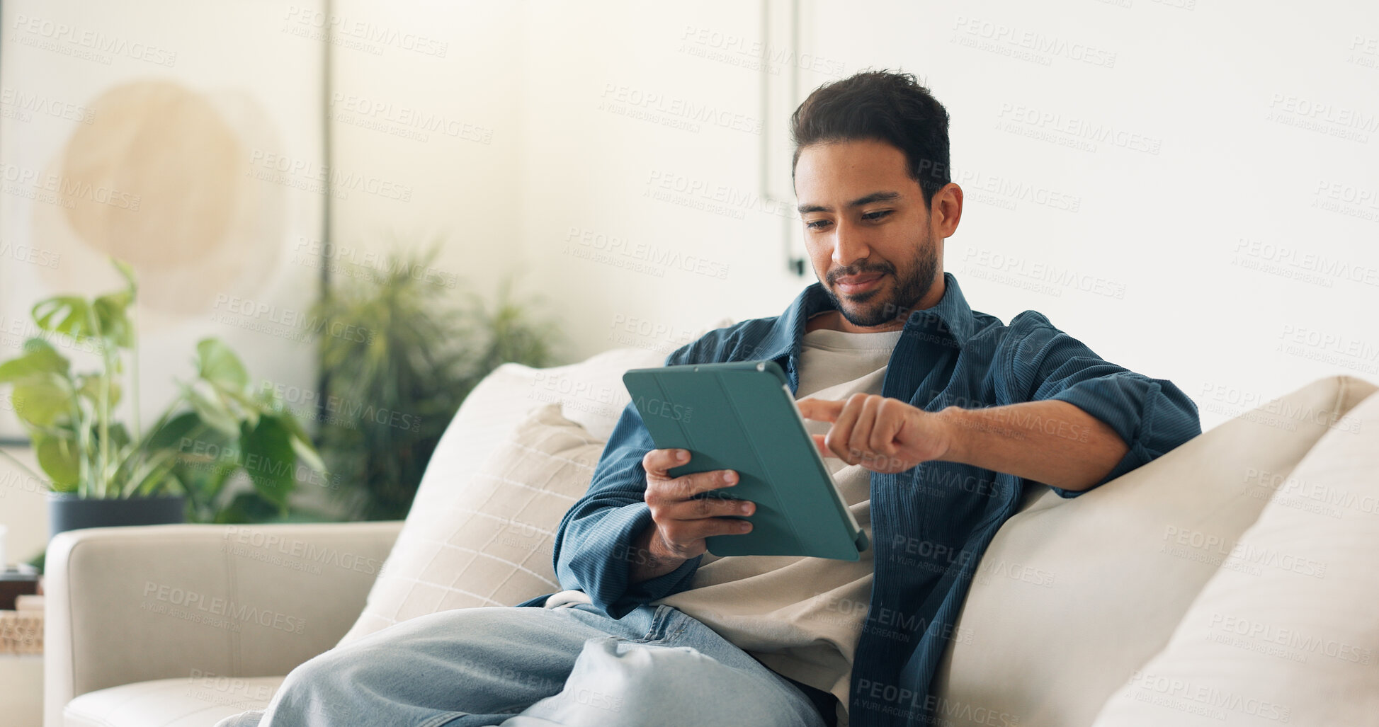 Buy stock photo Streaming, digital or man on sofa with tablet, video subscription or post update on online site. Smile, browse or person in house with tech, internet search or show binge on entertainment platform.