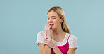 Nervous, woman and student in studio with anxiety, exam stress and academic pressure for education. Mockup space, person or biting nails with concern, poor grades and fail semester on blue background
