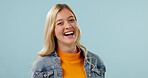 Wellness, portrait and happy woman in studio with laugh, positive attitude or feel good with confidence. Wellbeing, humor or person with space, upbeat moment and satisfaction on blue background.